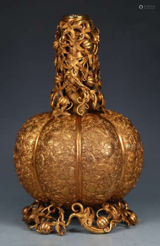 A GILT BRONZE CANDLE HOLDER SHAPED WITH MELON