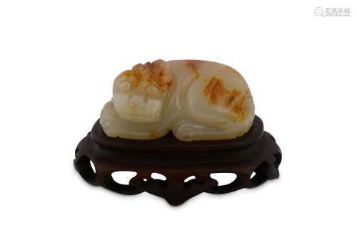 A CHINESE PALE CELADON JADE CARVING OF A LION.