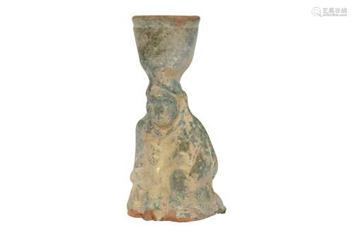 A CHINESE GREEN-GLAZED POTTERY CANDLESTICK.