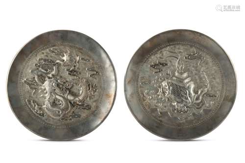 A PAIR OF CHINESE WHITE METAL CIRCULAR 'SHISHIN' PLAQUES.