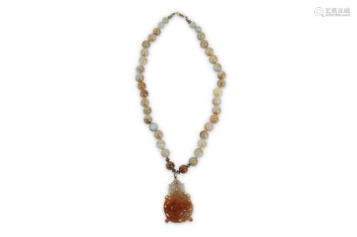 A CHINESE RUSSET JADE NECKLACE.