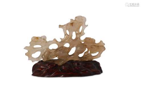 † A CHINESE AGATE 'BIRDS AND PINES' BRUSH REST.