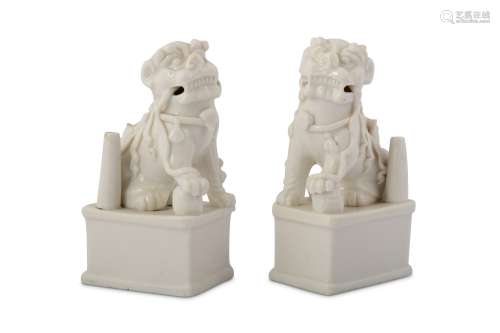 A PAIR OF CHINESE BLANC-DE-CHINE LION DOG JOSS STICK HOLDERS.