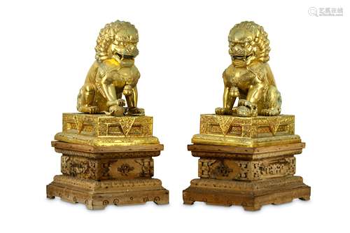 A PAIR OF LARGE CHINESE GILT-METAL LIONS AND STANDS.