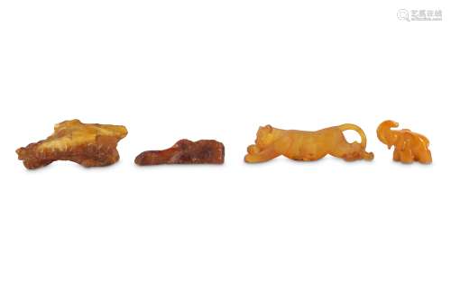 FOUR CHINESE AMBER CARVINGS.