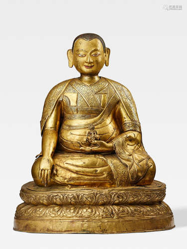 A LARGE GILT COPPER ALLOY REPOUSSÉ FIGURE OF A SAKYA LAMA TIBET, 17TH CENTURY