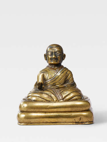 A SILVER AND COPPER INLAID BRASS FIGURE OF A KAGYU HIERARCH TIBET, 13TH/14TH CENTURY