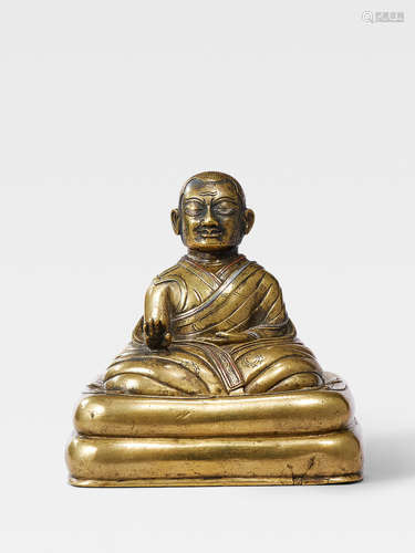 A SILVER AND COPPER INLAID BRASS FIGURE OF A KAGYU HIERARCH TIBET, 13TH/14TH CENTURY