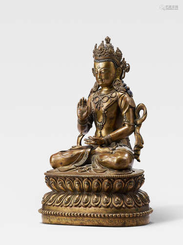 A BRASS FIGURE OF AMOGHASIDDHI TIBET, 15TH CENTURY