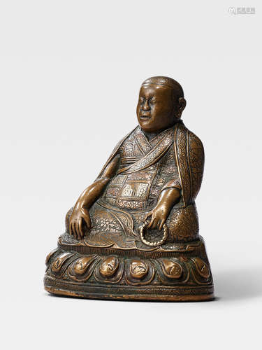 A SILVER AND COPPER INLAID BRASS FIGURE OF THE FOUNDER OF THE JONANG ORDER, DOLPOPA SHERAB GYALTSEN TIBET, 16TH CENTURY