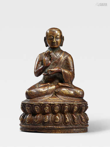 A SILVER INLAID BRASS ALLOY FIGURE OF THE SEVENTH ABBOT OF NGOR MONASTERY, KONCHOK PEL TIBET, 16TH CENTURY