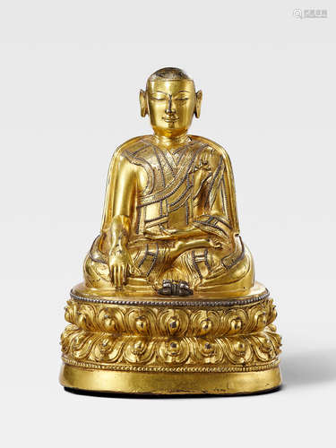 A SILVER INLAID GILT COPPER ALLOY FIGURE OF A TAKLUNG KAGYU LAMA TIBET, CIRCA 14TH CENTURY