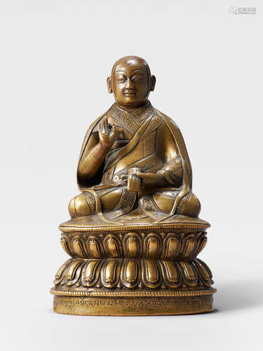 A SILVER AND COPPER INLAID BRASS FIGURE OF LOWO KHENCHEN SONAM LHUNDRUP, ABBOT OF THE KINGDOM OF LO TIBET, 16TH CENTURY