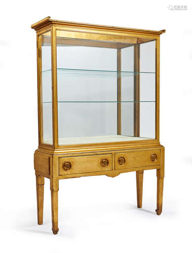 American School A Pair of Giltwood Vitrine Cabinets Late 19th/Early 20th Century conceived in Chinese taste and each in two sections, the upper sections each with glass top and sides, and door to the side, the lower sections with two drawers, with alterations height 79in (201cm); width 52in (132cm); depth 17in (43cm)