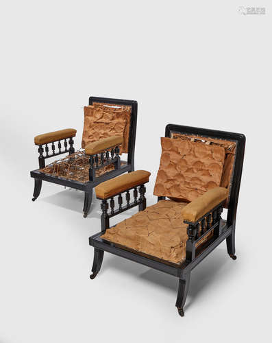 Herter Brothers (1864-1906) Pair of Library Armchairs circa 1880 possibly from the Marshall Field House, Chicago carved ebonized cherry, remnants of sprung upholstery, on original casters, one stamped 5233, the other 5768 to inside of proper right rear leg each of height 34 1/2in (88cm); width 26 3/4in (68cm); depth 31in (79cm)