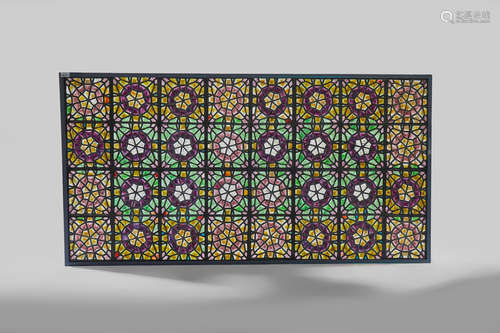 AMERICAN AESTHETIC MOVEMENT Oversized Islamic Revival Pebble Glass Window circa 1890 comprising thirty two square glass panels each composed of numerous varicolored rough glass pebbles and arranged in a circular star motif, within a modern steel frame height 87in (221cm); overall width 46 1/2in (119cm)