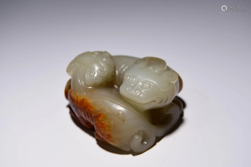 A CHINESE WHITE JADE CARVED BEAST ORNAM…