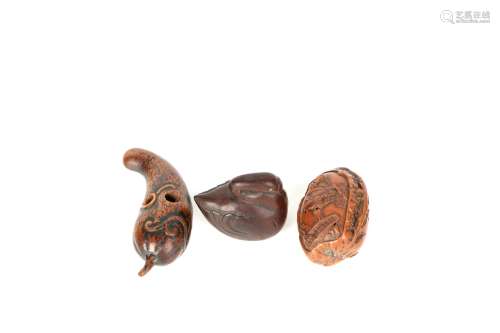 a group of three chinese walnut pendants