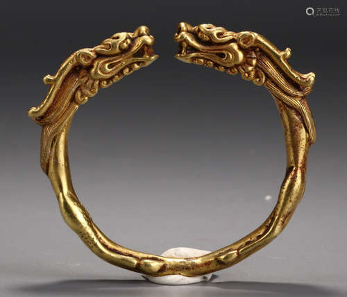 A GILT SILVER BANGLE CARVED WITH DRAGON