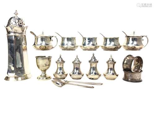 A LOT OF SILVER CONDIMENT JARS, SHAKERS AND NAPKIN RINGS