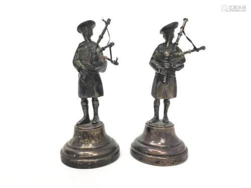 A PAIR OF SILVER FIGURES OF BAGPIPERS