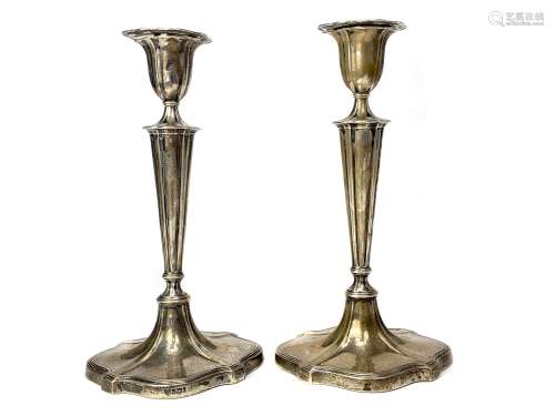 A SET OF FOUR TABLE CANDLESTICKS OF NEOCLASSICAL DESIGN