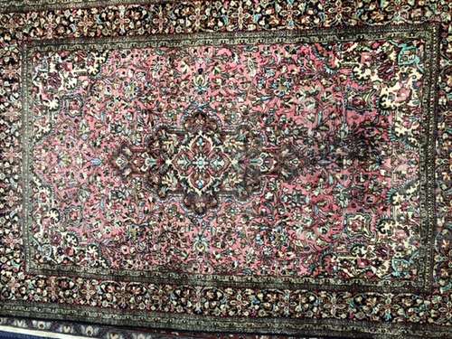 A 20TH CENTURY QUM RUG