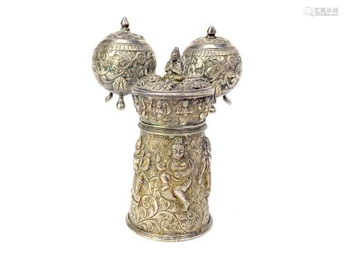 AN INDIAN WHITE METAL PEPPER GRINDER AND A PAIR OF METAL CONDIMENT CASTERS