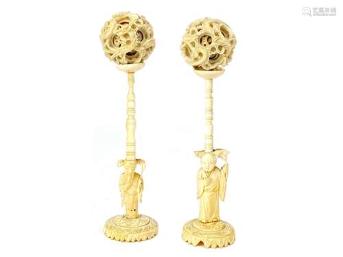 A LOT OF TWO EARLY 20TH CENTURY CHINESE IVORY CONCENTRIC BALLS ON STANDS