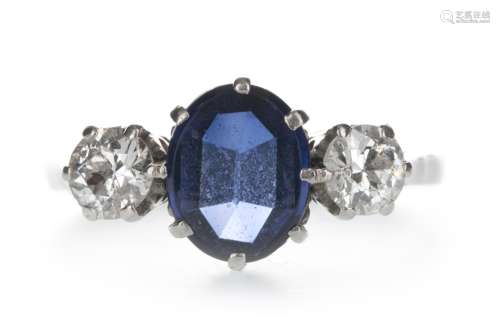 A BLUE GEM SET AND DIAMOND THREE STONE RING