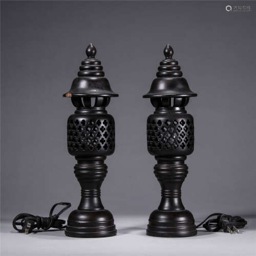 A pair of wooden hollowed-out carving lampstands