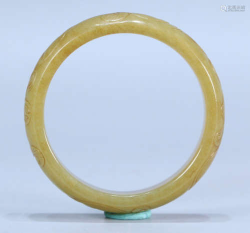 A HETIAN YELLOW JADE BANGLE CARVED WITH DRAGON