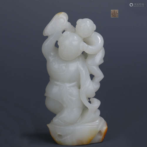 A CHINESE HETIAN JADE CARVED BOY ORNAMENT