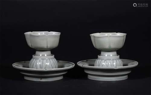 A PAIR OF LIAO DYNASTY CELADON HOLDERS