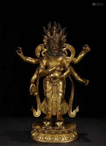 A QING DYNASTY BRONZE GILDED SIX ARMS DHARMA GUARD