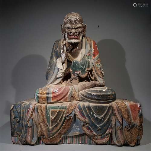 A MING DYNASTY CLAY PAINTED ARHAT STATUE