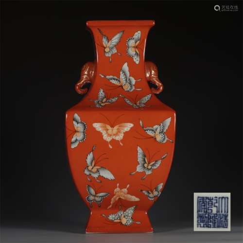 A QINGLONG'S SQUARE BOTTLE WITH RED ALUM GROUND AND FAMILLE ROSE BUTTERFLIES AND ELEPHANT TRUNK