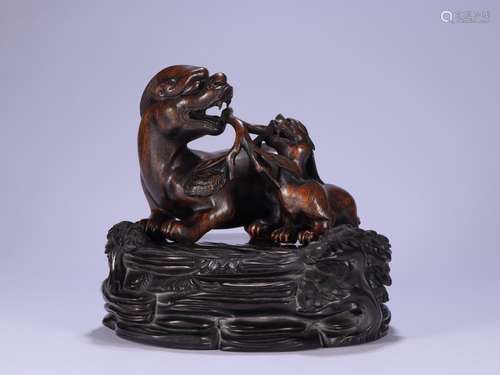 A Chinese Chenxiang Wood Ornament With Beast Carving