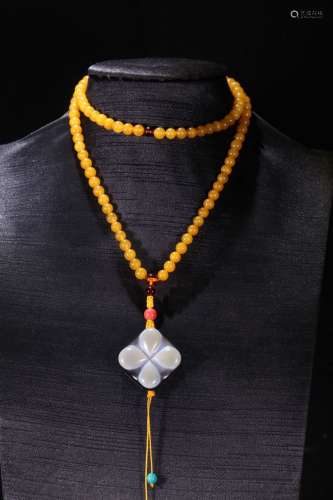 A Chinese Amber Necklace With Dzi
