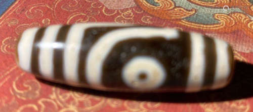 A TIBETAN DZI PENDANT