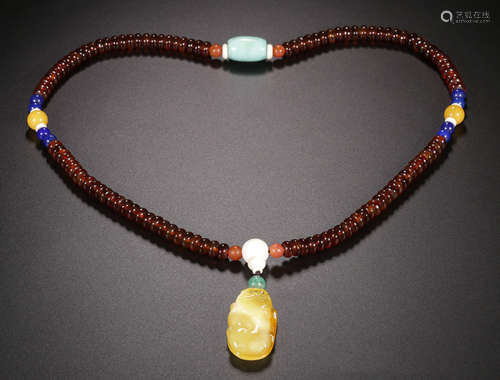 A TORTOISESHELL NECKLACE WITH BEESWAX