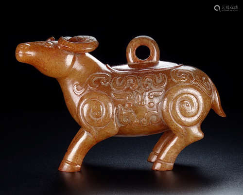 AN OLD HETIAN JADE CARVED BULL SHAPE PENDANT