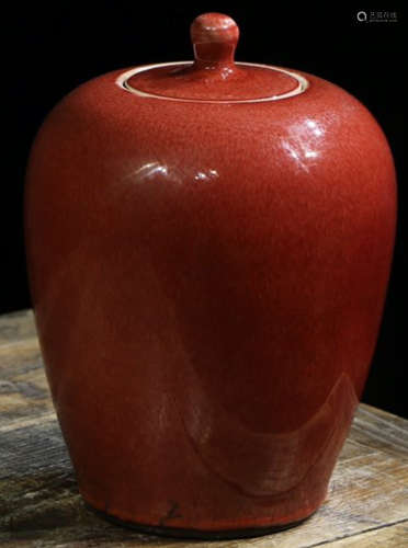 A RED GLAZE JAR WITH COVER
