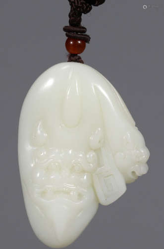 A HETIAN WHITE JADE PENDANT CARVED WITH BEAST
