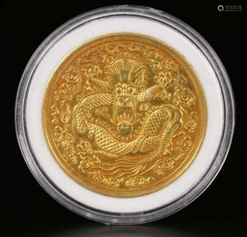 A GOLD COIN WITH DRAGON PATTERN