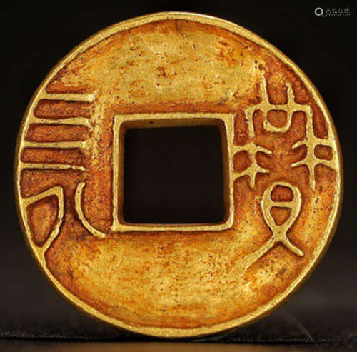 A GOLD COIN WITH PATTERN