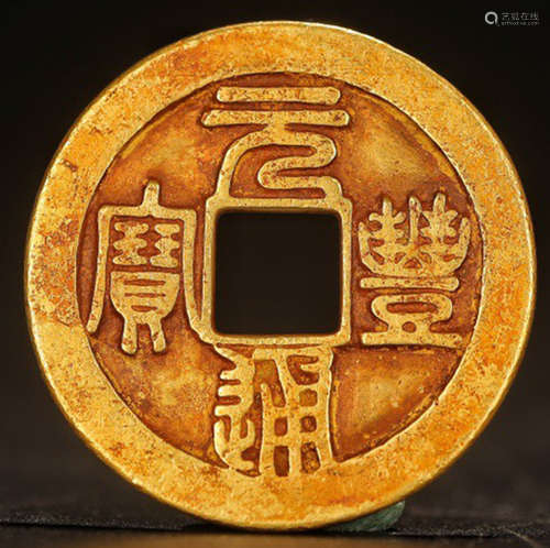 A GOLD COIN WITH PATTERN