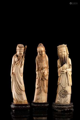 Three carved ivory figures, wood bases China, early 20th century (h. 30.5 cm.) This lot may be subject to Import/Export restrictions due to CITES regulations in some extra UE countries...
