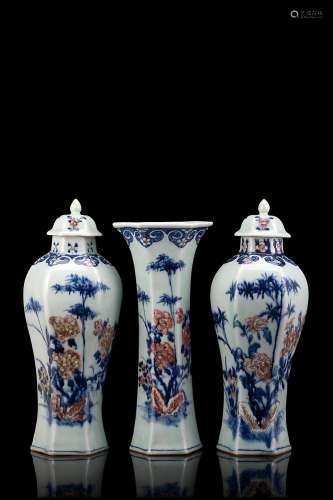 A celadon hexagonal porcelain set, comprising a vase and two potiches, decorated with blue and iron red blossoming branches (restorations) China, 19th century Provenance Milanese private collection Gianni Russo Antiquities (h. 29.5 cm.)...