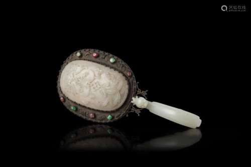 A silvered metal mirror mounted with white celadon jade and hardstones (slight defects) China, 19th century (l. 25.5 cm.)...